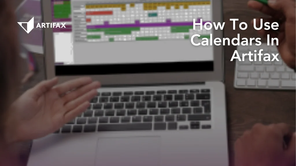 Laptop screen displaying a colour-coded Artifax calendar while two people discuss how to use the system