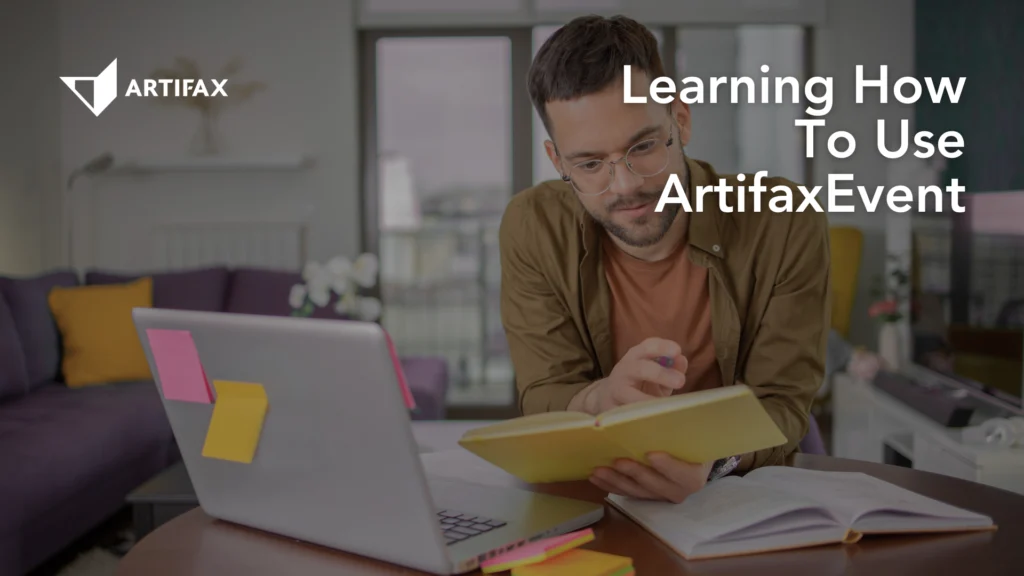 Man studying at home with a laptop and notebook while learning how to use ArtifaxEvent.