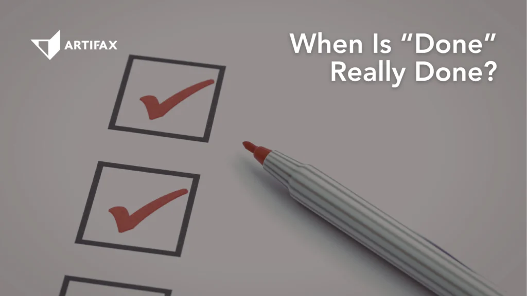 A checklist with red check marks and a pen resting beside it, suggesting task completion and reflection on what “done” truly means.