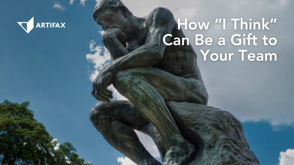 Statue of a seated figure deep in thought against a cloudy sky