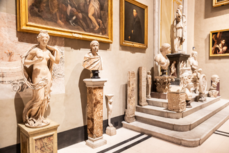 Marble sculptures and classical art displayed in an ornate gallery.