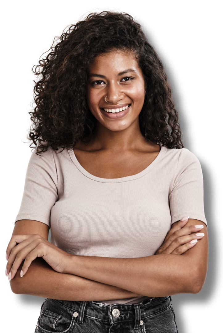 Smiling woman with curly hair standing confidently with arms crossed.