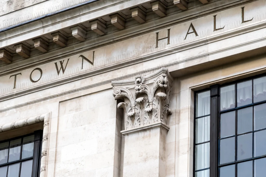 Stone facade of a traditional town hall building with carved columns.