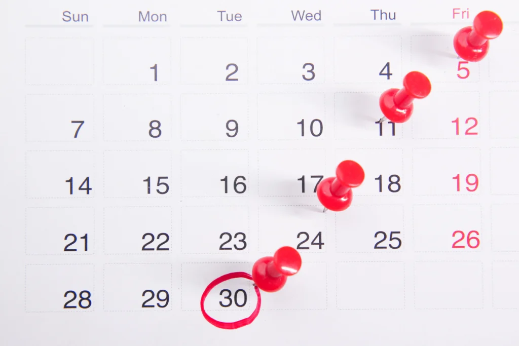 Calendar marked with red pins and a date circled in red.
