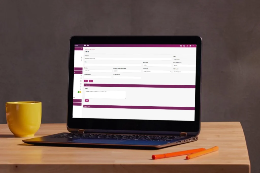 Laptop on a desk displaying Artifax event details form.