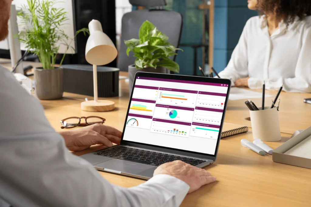 Person using a laptop displaying Artifax dashboard analytics and charts.