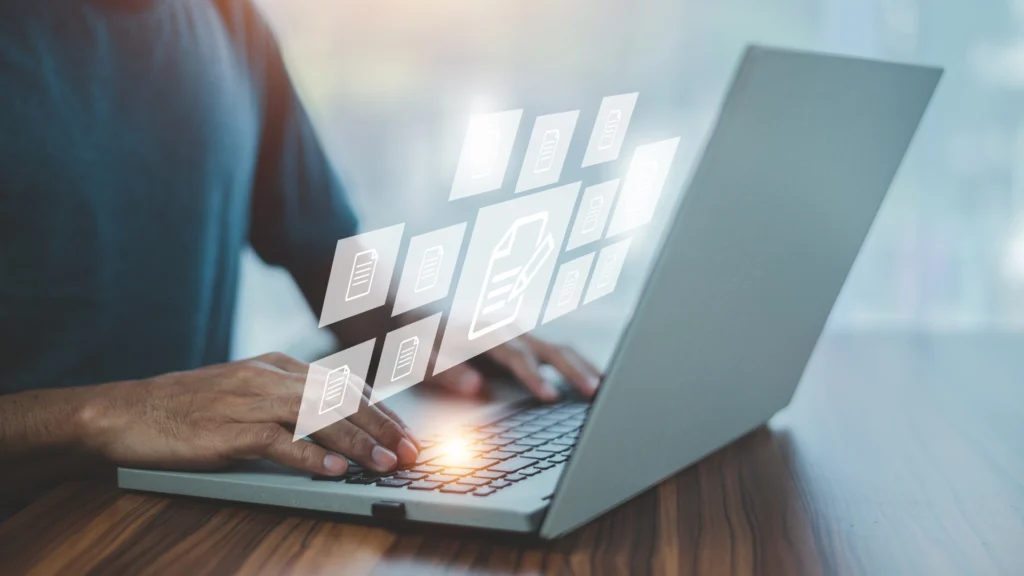 Person typing on a laptop with floating digital file icons.