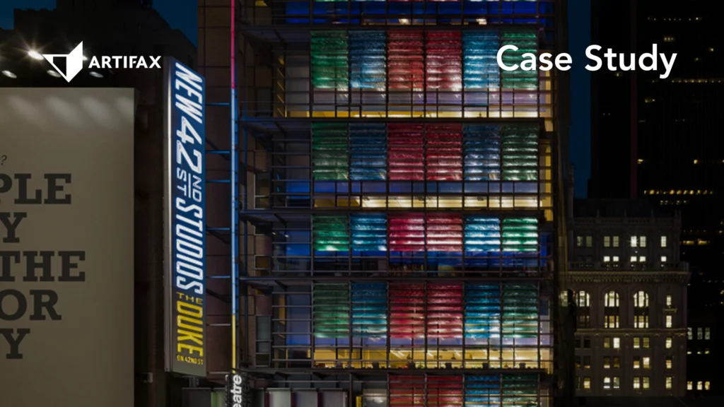 Exterior of New 42 Studios in New York City illuminated at night with colourful window lighting.