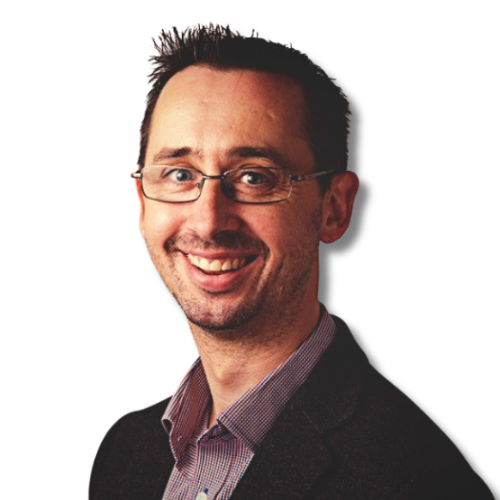 Smiling man wearing glasses and a dark blazer