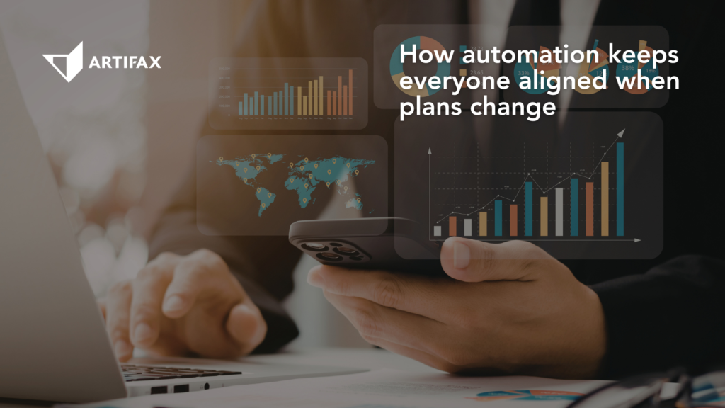 Business professional using a smartphone and laptop with data dashboards, illustrating how automation improves communication and keeps teams aligned when plans change