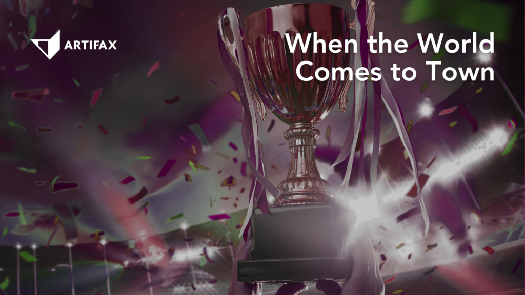 Championship trophy surrounded by confetti in a stadium with the headline "When the World Comes to Town" and Artifax branding.